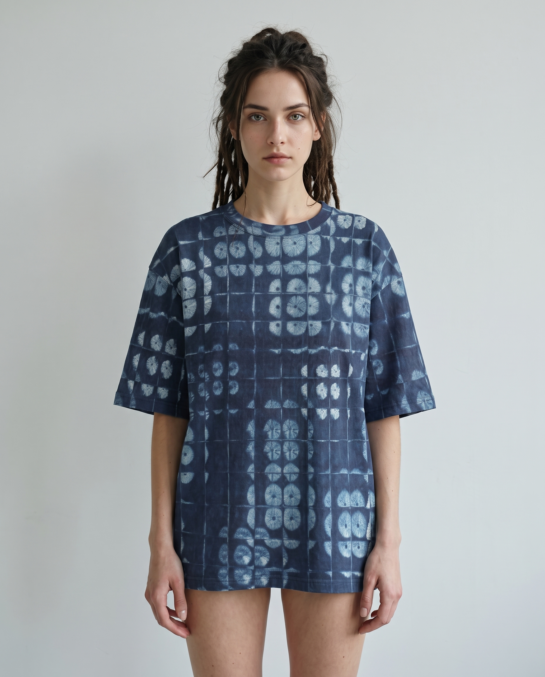 Mia wearing Spore Shibori oversized T-shirt in a minimal studio