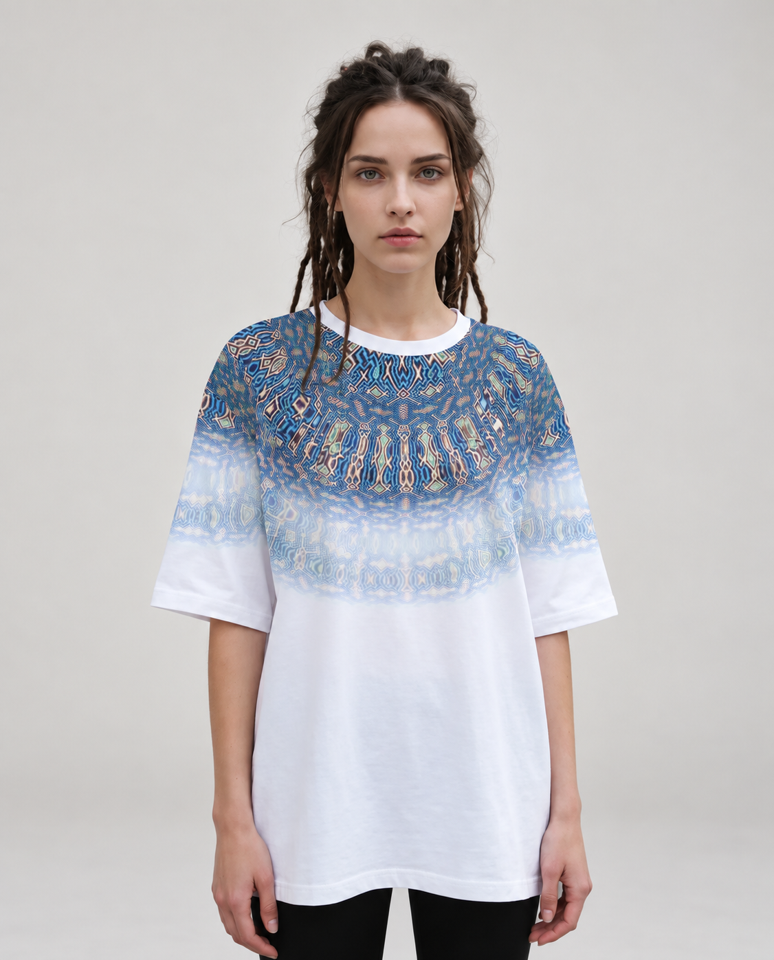 Mia wearing Liquid Kaleidoscope oversized T-shirt, soft-light neutral studio